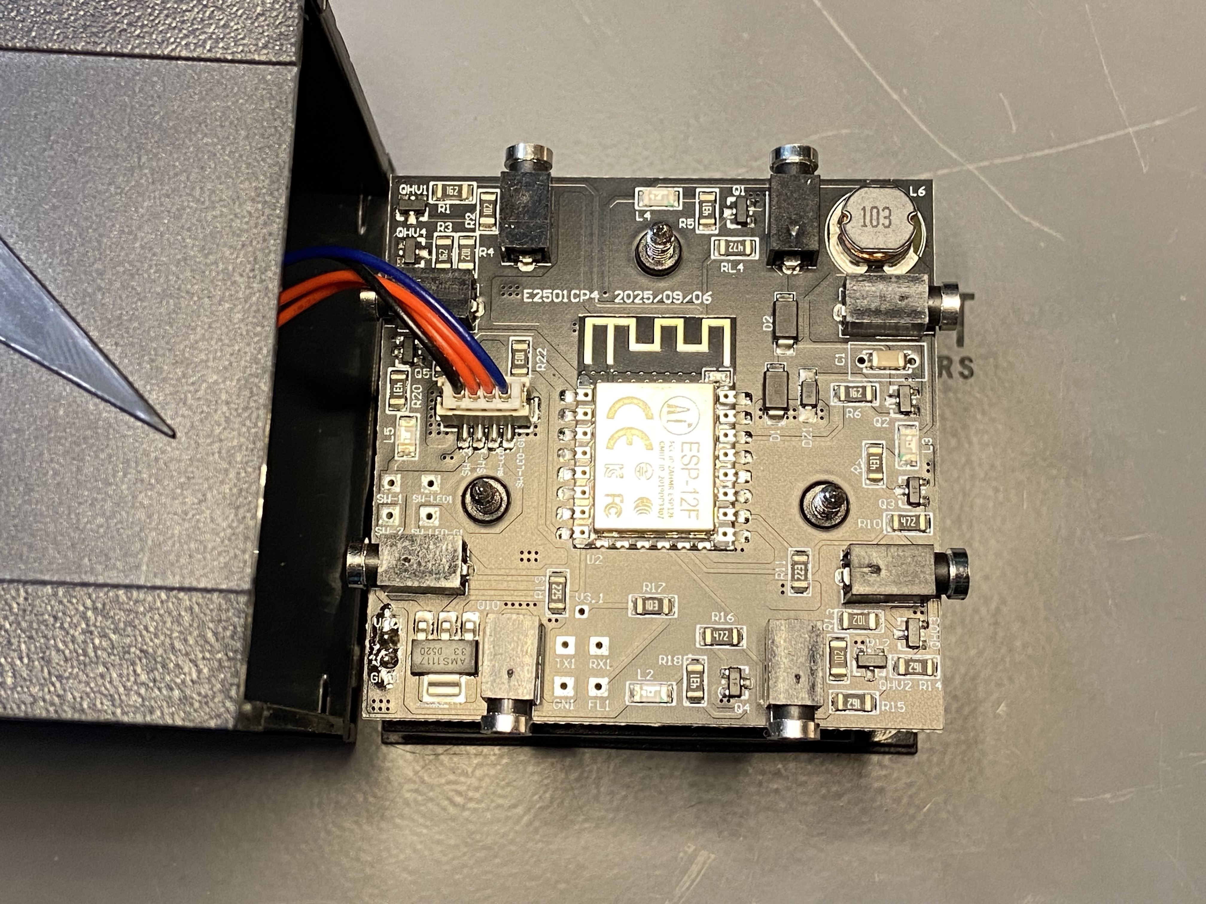 The exposed PCB, including the ESP-12F module and labeled vias.
